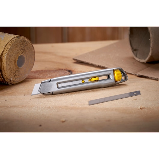 Foto van STANLEY 0-10-018 hobbymes met gele accenten en extra mes op werkbank, productcategorie: Fotografie.