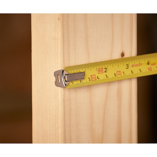 STANLEY 0-33-158 rolmaat close-up op hout, gele band met zwarte markeringen, fotografie product.