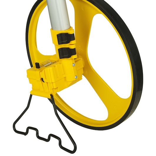 Photo de la roue de mesure STANLEY 1-77-174, vue de côté en gros plan montrant la roue jaune, la poignée et le support noir.