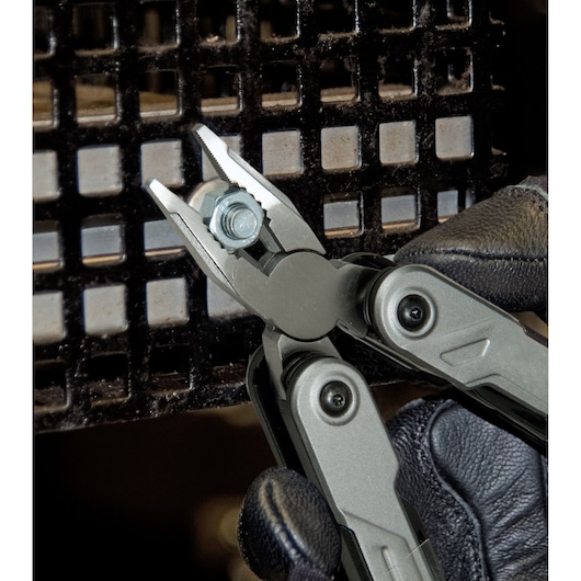 STANLEY FMHT0-72414 multitool tang pakt een bout vast, close-up met gehandschoende hand.