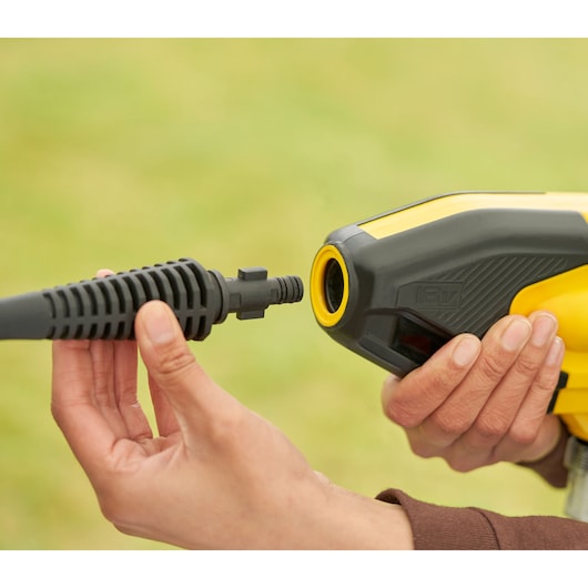 STANLEY SFMCPC93B draagbare was nozzle aansluiting, close-up, geel-zwart behuizing in hand.