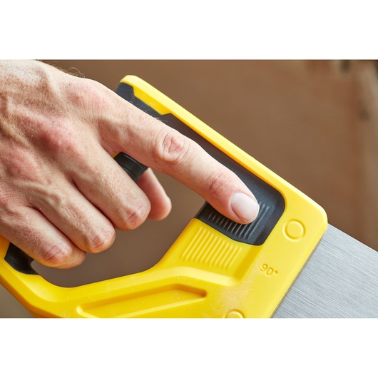 STANLEY STHT1-20353 handzaag close-up, gele handgreep met zwart gripvlak, vinger op instelfunctie.