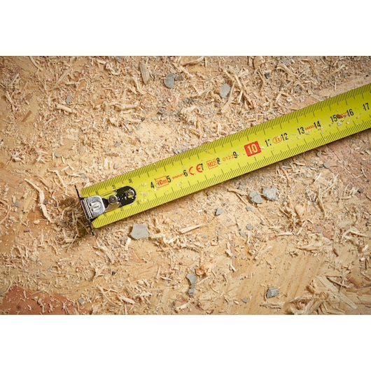 STANLEY STHT37233 gele rolmaat op hout met zaagsel, close-up fotografie.