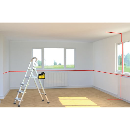 STANLEY STHT77504-1 laserwaterpas op ladder in lichte kamer, projecteert rode laserlijnen horizontaal en verticaal.