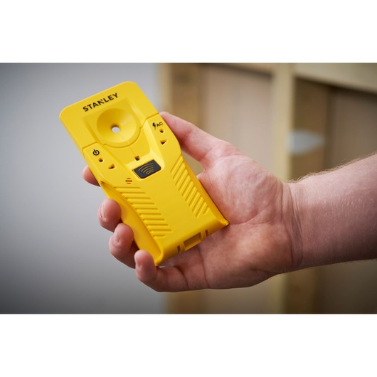 STANLEY STHT77587-0 gele balkendetector in hand gehouden, voorkant, fotografieproduct.
