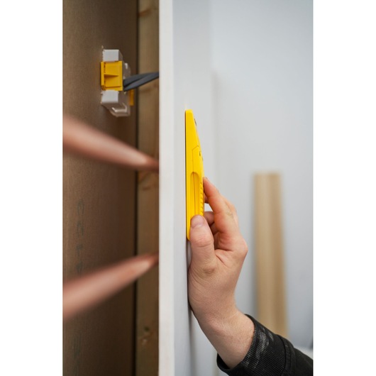 Foto van STANLEY STHT77587-0 gele wandscanner tegen gipsplaat in gebruik.