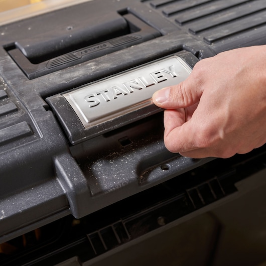 Foto van de STANLEY STST1-70715 gereedschapskistsluiting die wordt geopend, close-up.