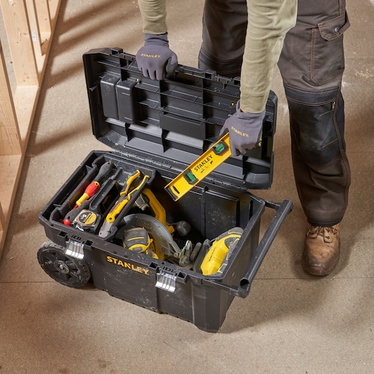 Photo de la boîte à outils roulante STANLEY STST1-80150 remplie d'outils à main et électroportatifs, vue du dessus, couvercle ouvert.